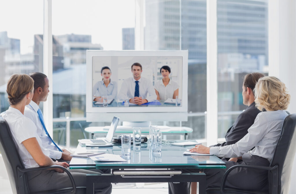 Business team having video conference with another business team